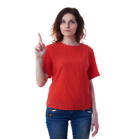 Smiling young woman in casual clothes over white isolated background pointing,showing direction or pushing button, happy people conceptの写真素材