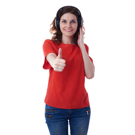 Smiling young woman in casual clothes over white isolated background with headphones, happy people, music, technology, resting conceptの写真素材