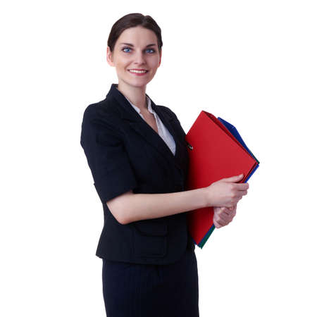 Smiling businesswoman standing over white isolated background with red folders in hands, business, education, office conceptの写真素材