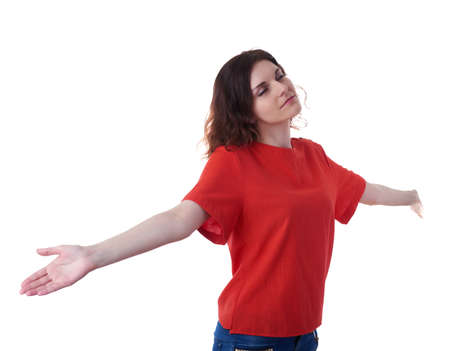Smiling young woman in casual clothes over white isolated background with widely placed hands, happy people, enjoying freedom conceptの写真素材
