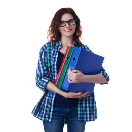 Smiling young woman in casual clothes and glasses over white isolated background with a heap of folders, happy people and lot of work conceptの写真素材