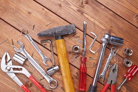 Set of different work tools on wooden brown surfaceの写真素材