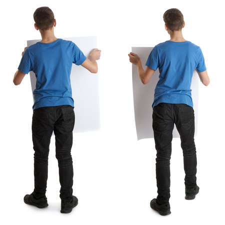 Cute teenager boy in blue T-shirt with banner in hands standing over white isolated background full body from backの写真素材