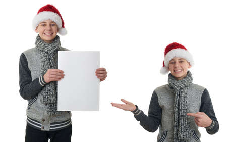 Set of cute teenager boy in gray sweater and christmas hat holding paper over white isolated background, half bodyの写真素材