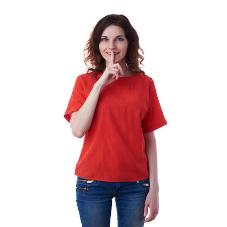 Smiling young woman in casual clothes over white isolated background with finger over mouth, happy people, silence conceptの写真素材