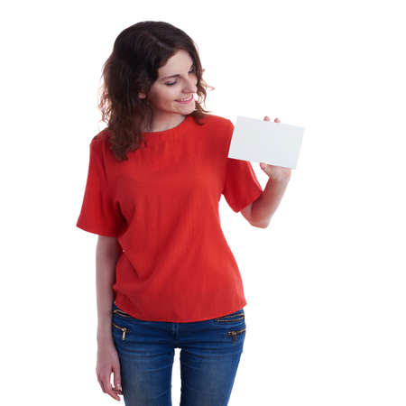 Smiling young woman in casual clothes over white isolated background with blank card in hand, happy people, advertising conceptの写真素材