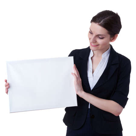 Smiling businesswoman standing over white isolated background with white blank board, business, education, office, advertising conceptの写真素材