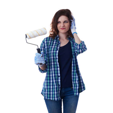 Young woman in casual clothes over white isolated background paint roller, happy people and construction conceptの写真素材
