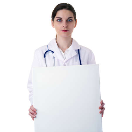 Smiling female doctor in white coat over white isolated background with stethoscope and white blank board, healthcare, profession and medicine conceptの写真素材