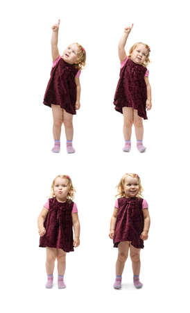 Young little girl with curly hair in purple dress standing over isolated white backgroundの写真素材