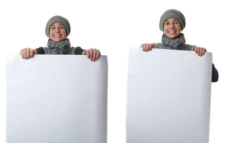 Set of cute teenager boy in gray sweater, hat and scarf holding paper bill board over white isolated background, half bodyの写真素材