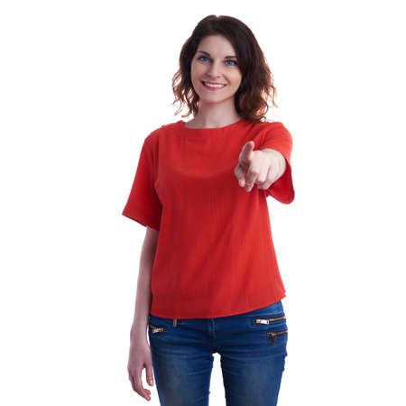 Smiling young woman in casual clothes over white isolated background pointing, showing direction or pushing button, happy people conceptの写真素材