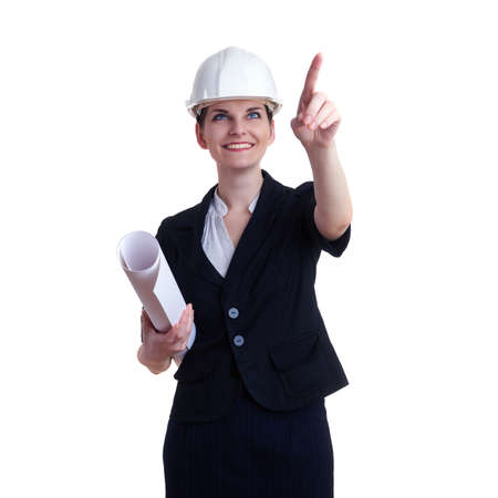 Smiling businesswoman standing over white isolated background in white helmet with blueprint, business, education, construction and architecture conceptの写真素材