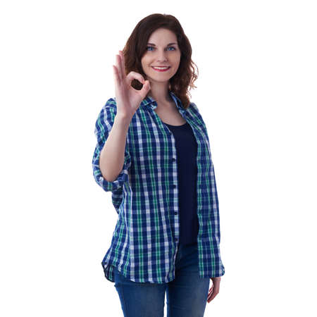 Smiling young woman in casual clothes over white isolated background showing OK sign, happy people conceptの写真素材