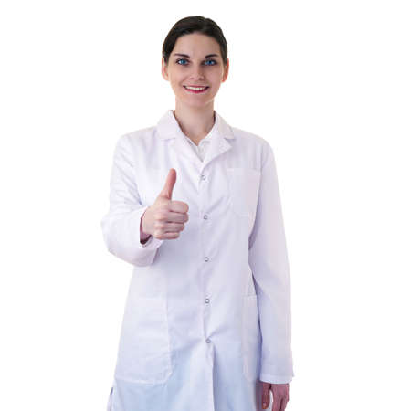 Smiling female doctor assistant scientist in white coat over white isolated background showing thumb up sign, healthcare, profession, science and medicine conceptの写真素材