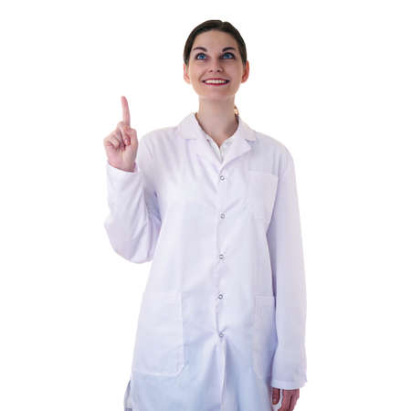 Smiling female doctor assistant scientist in white coat over white isolated background and pointing up, healthcare, profession, science and medicine conceptの写真素材