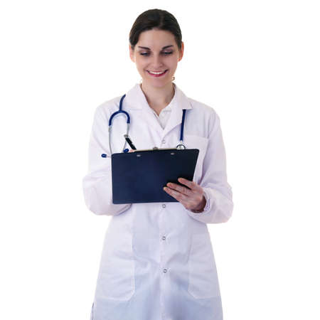 Smiling female doctor in white coat over white isolated background with stethoscope and clipboard, healthcare, profession and medicine conceptの写真素材