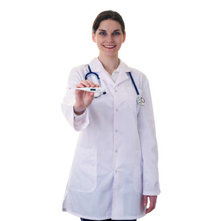 Smiling female doctor in white coat over white isolated background with stethoscope and thermometer, healthcare, profession and medicine conceptの写真素材