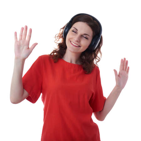Smiling young woman in casual clothes over white isolated background with headphones, happy people, music, technology, resting conceptの写真素材