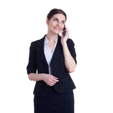 Smiling businesswoman standing over white isolated background with tablet smart phone, business, education, office, technology conceptの写真素材