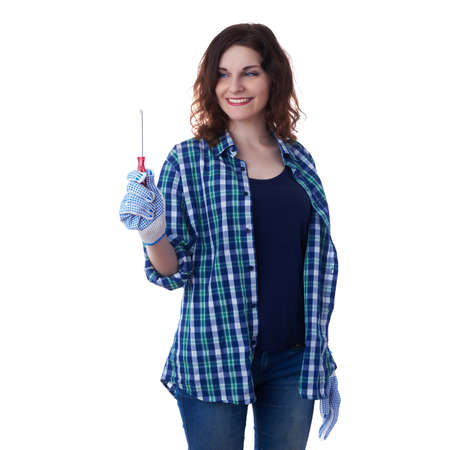 Smiling young woman in casual clothes over white isolated background holding screwdriver, happy people and construction conceptの写真素材