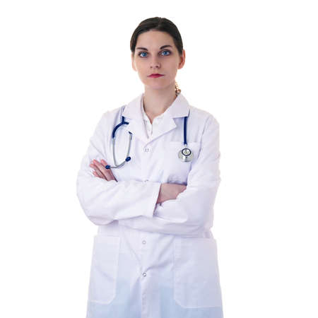 Female doctor assistant in white coat over white isolated background with stethoscope and crossed arms, healthcare, profession and medicine conceptの写真素材