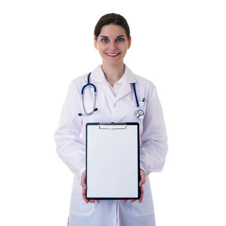 Smiling female doctor in white coat over white isolated background with stethoscope and blank clipboard, healthcare, profession and medicine conceptの写真素材