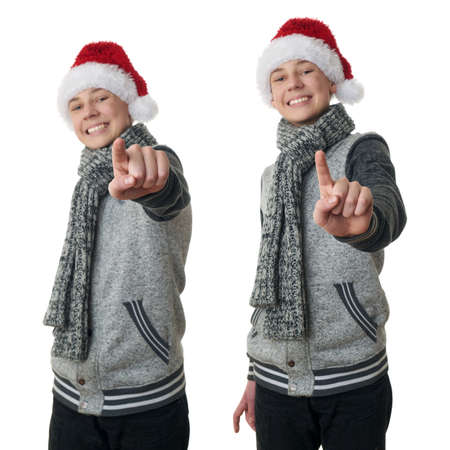 Set of cute teenager boy in gray sweater and christmas hat pointing forward over white isolated background, half bodyの写真素材