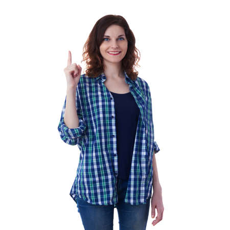Smiling young woman in casual clothes over white isolated background pointing up, happy people conceptの写真素材