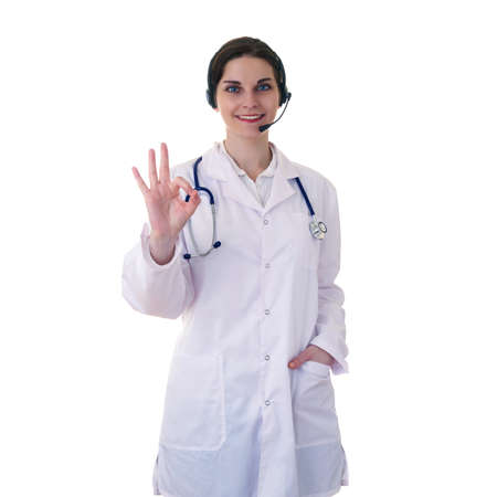 Smiling female doctor in white coat over white isolated background with stethoscope and headphones with microphone, healthcare, profession and medicine conceptの写真素材