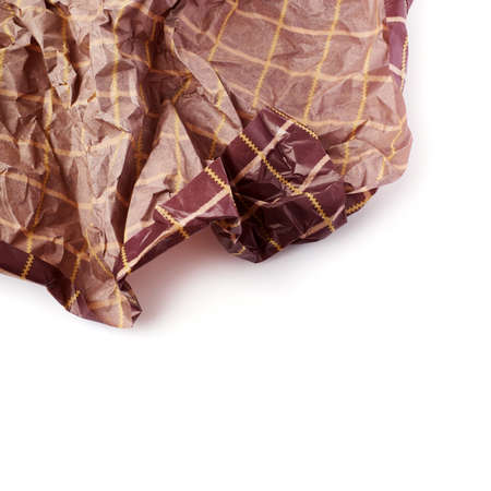 Crumpled brown paper isolated over white backgroundの写真素材