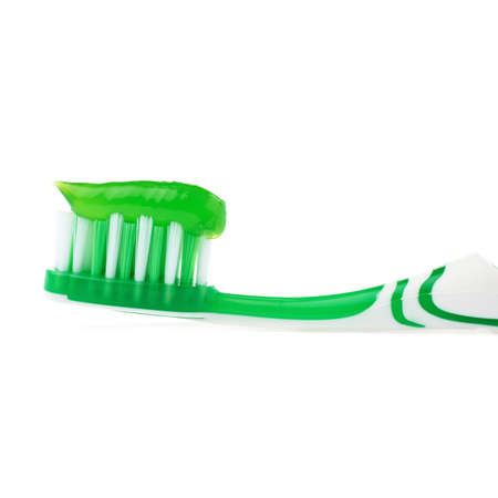 Green single toothbrush with paste isolated over white backgroundの写真素材