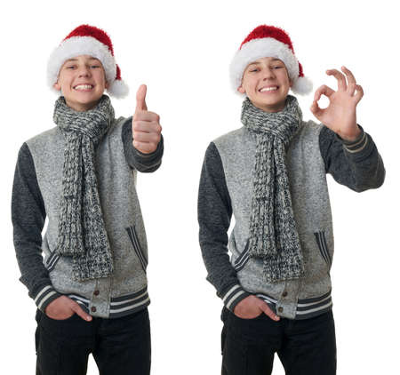Set of cute teenager boy in gray sweater and christmas hat showing thumb up sign over white isolated background, half bodyの写真素材