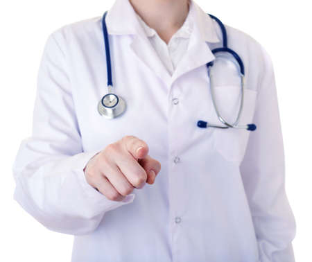 Female doctor in white coat over white isolated background with stethoscope pointing, showing direction or pushing button, healthcare, profession, and medicine conceptの写真素材