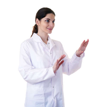 Smiling female doctor assistant scientist in white coat over white isolated background working with virtual screen, healthcare, profession, science and medicine conceptの写真素材