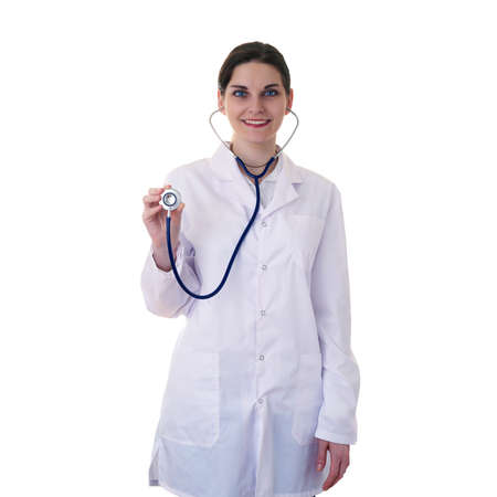 Smiling female doctor in white coat over white isolated background using stethoscope, healthcare, profession and medicine conceptの写真素材