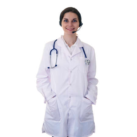Smiling female doctor in white coat over white isolated background with stethoscope and headphones with microphone, healthcare, profession and medicine conceptの写真素材