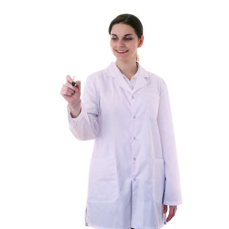 Smiling female doctor assistant scientist in white coat over white isolated background writting something with marker, healthcare, profession, science and medicine conceptの写真素材