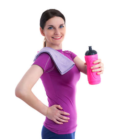 Smiling sporty woman in violet T-short with pink drinking bottle and purple towel over white isolated background, fitness, sport and lifestyle conceptの写真素材