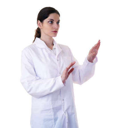 Smiling female doctor assistant scientist in white coat over white isolated background working with virtual screen, healthcare, profession, science and medicine conceptの写真素材