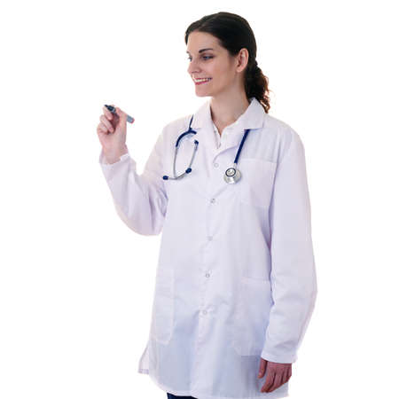 Smiling female doctor in white coat over white isolated background with stethoscope and marker in hand, healthcare, profession and medicine conceptの写真素材