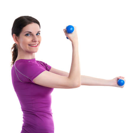 Smiling sporty woman in violet T-short doing exercises with blue dumbbells over white isolated background, fitness, sport and lifestyle conceptの写真素材