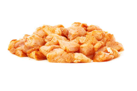 Raw chicken fillet breast cut into pieces and spiced isolated over white backgroundの写真素材