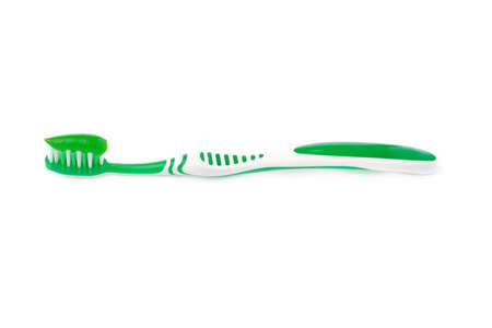 Green single toothbrush with paste isolated over white backgroundの写真素材