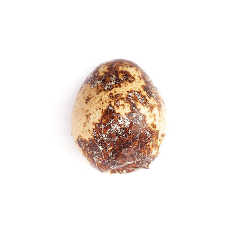 Single cracked quail egg isolated over white backgroundの写真素材