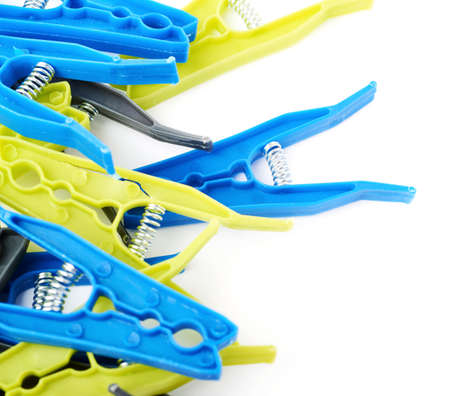 Pile of plastic cloth pegs isolated over white backgroundの写真素材