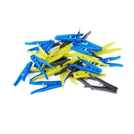 Pile of plastic cloth pegs isolated over white backgroundの写真素材