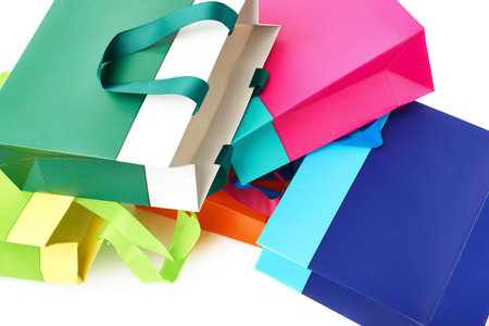 Pile of colorful shopping or gift bags isolated over the white background