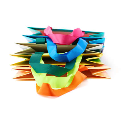 Pile of colorful shopping or gift bags isolated over the white backgroundの写真素材