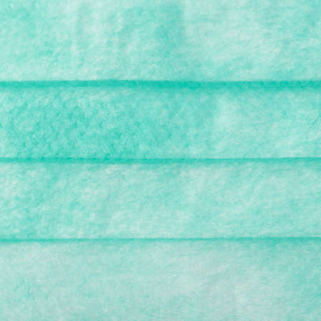 Green medical surgical flu illness protective mask texture as abstract backgroundの写真素材